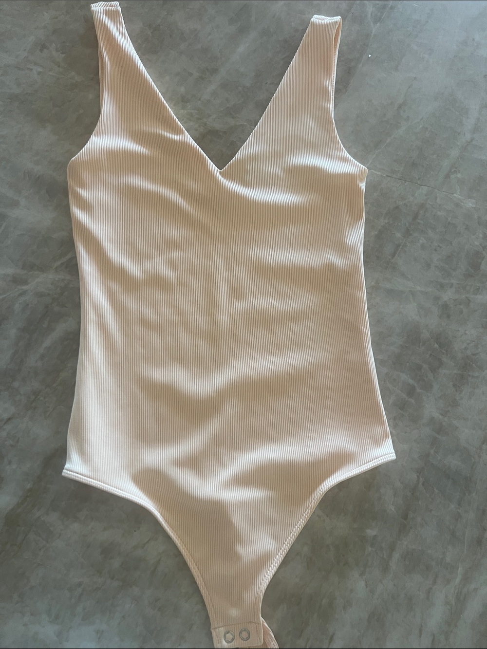 Express Body Contour Ribbed Bodysuit. Light orange/peach. small.